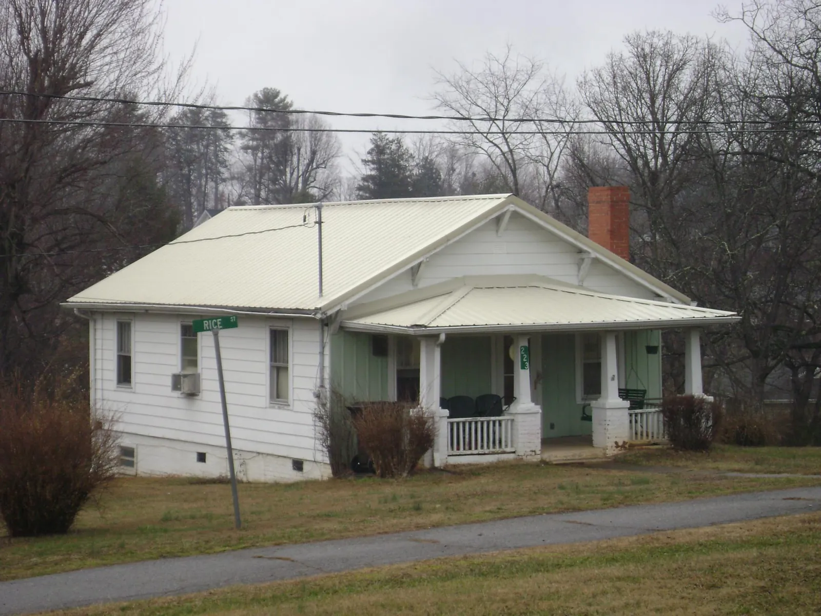 White metal roof on a craftsman bungalow at a street corner in Lincoln